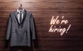 Suit hanging on the wooden wall, concept of a new job opportunity, career, we are hiring