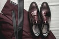 Suit, necktie, leather shoes on a white textile. Grooms wedding morning. Close up of modern man accessories