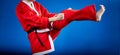 In a suit of Santa Claus the sportswoman is beating kicking