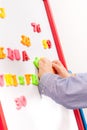 Suit up small young boy working on the chalkboard