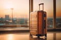 Suitcase awaits adventure in front of airport windows Royalty Free Stock Photo