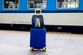 Suitcase and bag in colors of Ukraine flag at railway station, Prague, Czech Republic. Journey of Ukrainians, refugees, migrants. Royalty Free Stock Photo