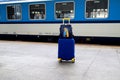 Suitcase and bag in colors of Ukraine flag at railway station, Prague, Czech Republic. Journey of Ukrainians, refugees, migrants. Royalty Free Stock Photo