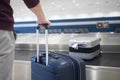 Suitcase in baggage claim in airport terminal Royalty Free Stock Photo