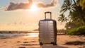 Suitcase on the beach background. Grey travel luggage on white tropical sand near sea ocean. Summer holidays. Vacations trip.