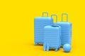 Suitcase with beach ball and flip flops on monochrome yellow background. Royalty Free Stock Photo