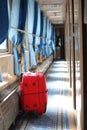 Suitcase in corridor of railway wagon Royalty Free Stock Photo