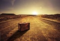 suitcase on a desert road