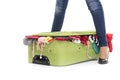 Suitcase between female legs. Royalty Free Stock Photo
