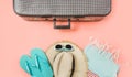 Suitcase with female outfit for beach on pink. Top view with copy space. Summer tropical vacatons Royalty Free Stock Photo