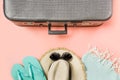 Suitcase with female outfit for beach on pink. Top view with copy space. Summer tropical vacatons Royalty Free Stock Photo