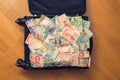 Suitcase full money of south-east Asia and American hundred dollar bill. Currency of Hong Kong, Indonesia, Malaysia, Thai, Singapo Royalty Free Stock Photo