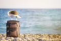 Suitcase and hat on beach Royalty Free Stock Photo