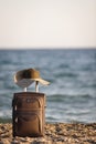 Suitcase and hat on beach Royalty Free Stock Photo