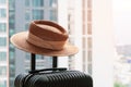 Suitcase and hat in hotel room