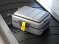 Suitcase with lost sticker on an airport baggage conveyor or baggage claim transporter