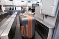 Suitcase on luggage conveyor belt system at check in desk in air