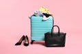 Suitcase, messy clothes, bag and shoes on pink background Royalty Free Stock Photo