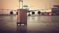 A suitcase on a runway with blurred airplane in the background. Business travel concept.