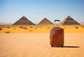 Suitcase sitting in the middle of a desert. Egypt pyramids on background. Minimalist touristic concept