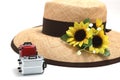 Suitcase, straw hat, sunflower on white background.