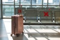 Suitcase at waiting chairs of airport departure terminal Royalty Free Stock Photo