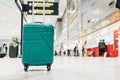 Suitcases in airport departure terminal with traveler people walking in background,Holiday vacation concept, Business