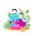 Suitcases on the beach. Travel bag with hat on the sunny beach. Giant inflatable Pink Flamingo.Flipflop, ball and palm Royalty Free Stock Photo