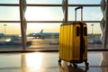 Suitcases with luggage in airport departure lounge with airplane in background. Traveler suitcases in airport terminal waiting Royalty Free Stock Photo