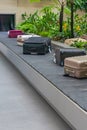 Suitcases on luggage conveyor belt at baggage claim waiting lounge Royalty Free Stock Photo