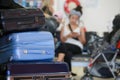 Suitcases, luggage, on trolley in  airport waiting room. Black, blue, very peri color baggage. Royalty Free Stock Photo