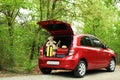 Suitcases, teddy bear and hat in car trunk Royalty Free Stock Photo