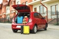 Suitcases, toy and hat in car trunk Royalty Free Stock Photo