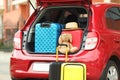 Suitcases, toy and hat in car trunk Royalty Free Stock Photo