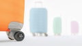 Suitcases on wheels with automobile tires of different colors, fragment, 3D render, travel, tourism, road