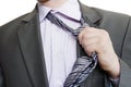 Suited man tearing off his tie on white background