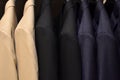 Suits on a clothing hanger. Merchandizing of clothes in a boutique. Royalty Free Stock Photo