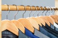 Suits for men hanging on the rack. Mens suits in different colors hanging on hanger in a retail clothes store, close-up Royalty Free Stock Photo