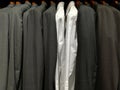 Suits for men in a shop and two white shirts Royalty Free Stock Photo