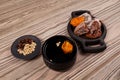 Sujeonggwa- Korean cold fruit tea or chilled punch on wooden table. It is made from dried or fresh persimmons gotgam and