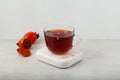 Sujeonggwa - Korean persimmon tea in clear cup. Side view, selective focus