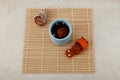 Sujeonggwa- traditional Korean cold fruit tea or chilled punch on bamboo mat. Top view, selective focus
