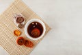 Sujeonggwa- traditional Korean cold fruit tea or chilled punch on marble surface. Top view, selective focus