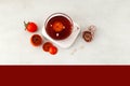 Sujeonggwa - Traditional Korean fruit tea or Persimmon punch in clear cup, top view. Light stone background, space for text