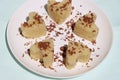 Suji Halwa or sheera, Indian sweet dish. Semolina dessert served in preety heart shape cake