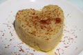 Suji Halwa or sheera, Indian sweet dish. Semolina dessert served in preety heart shape cake