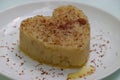 Suji Halwa or sheera, Indian sweet dish. Semolina dessert served in preety heart shape cake