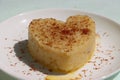 Suji Halwa or sheera, Indian sweet dish. Semolina dessert served in preety heart shape cake