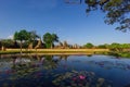 Temple pagoda and buddha statue with blue sky at Sukhothai Historical Park