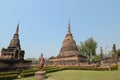 Wat Sa Si temple ruins, with classic walking Buddha image & bell-shaped Lanka-style stupa, with a large seated Buddha, Thailand